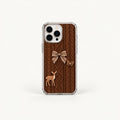 A clear iPhone case with a brown faux-knit cable pattern design, featuring a brown bow, butterfly, and deer graphic, shown on a light off-white background.