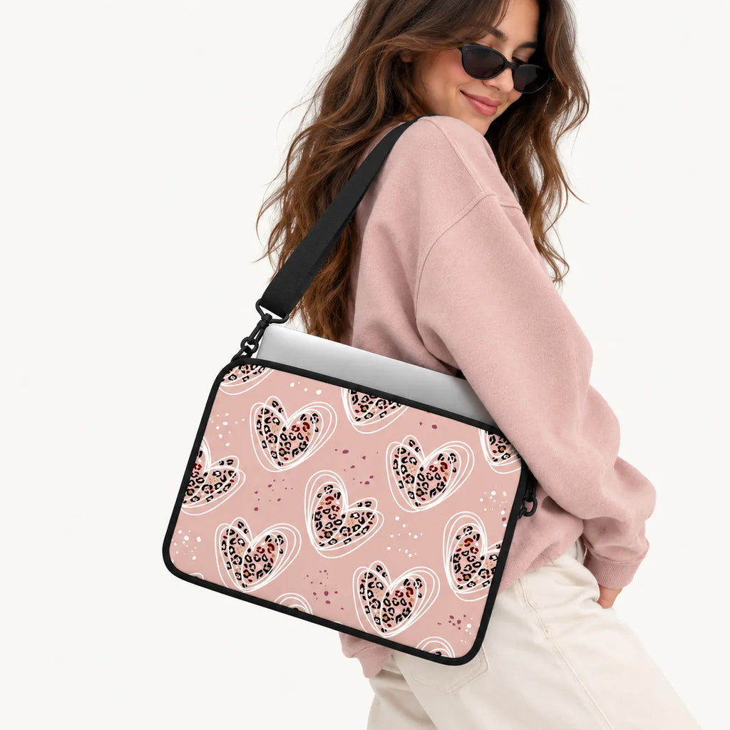 Dusty pink laptop sleeve printed with leopard pattern hearts encircled by white line art by SLEEVER