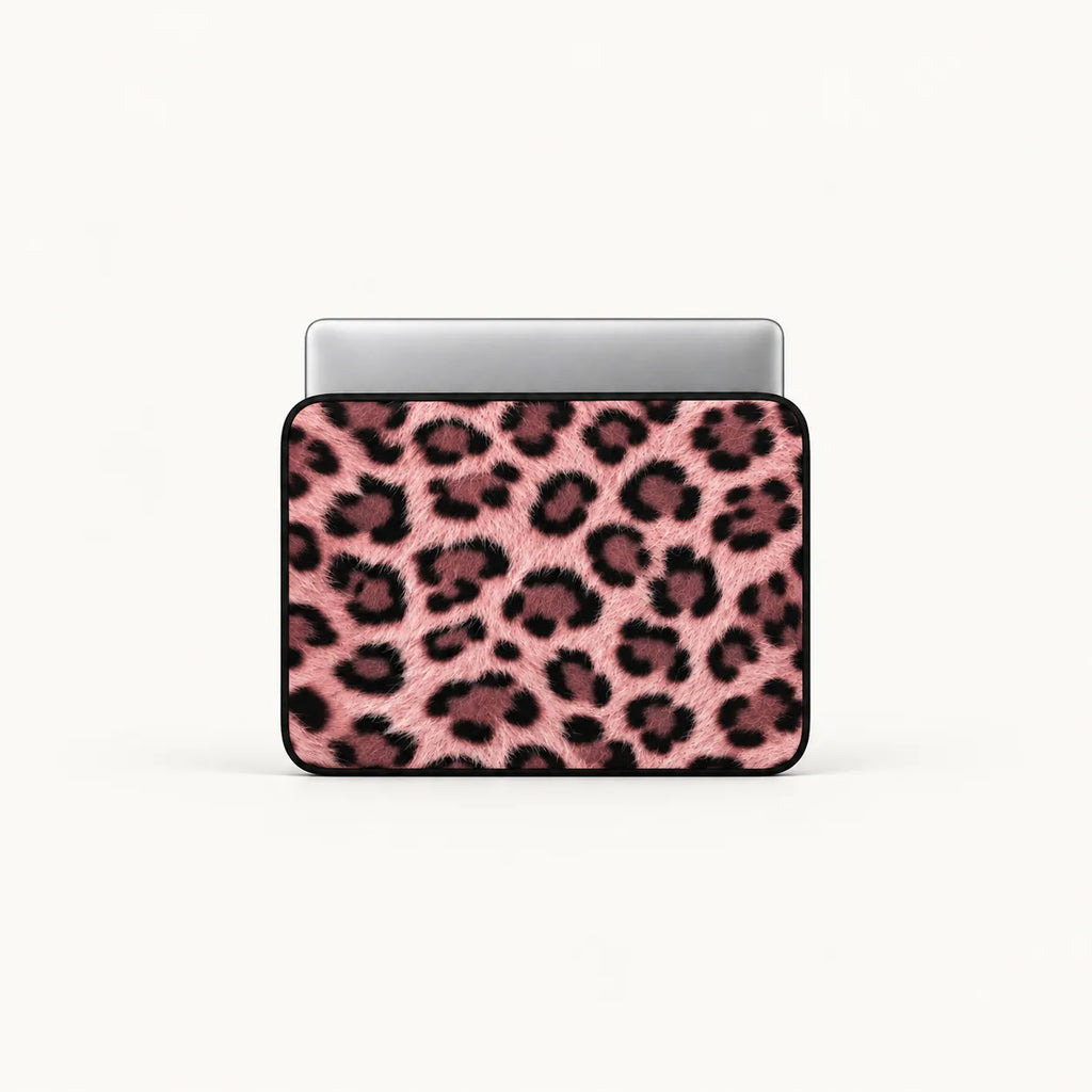 A laptop sleeve featuring a pink and black leopard print pattern, shown with a silver laptop inside on a clean white background.