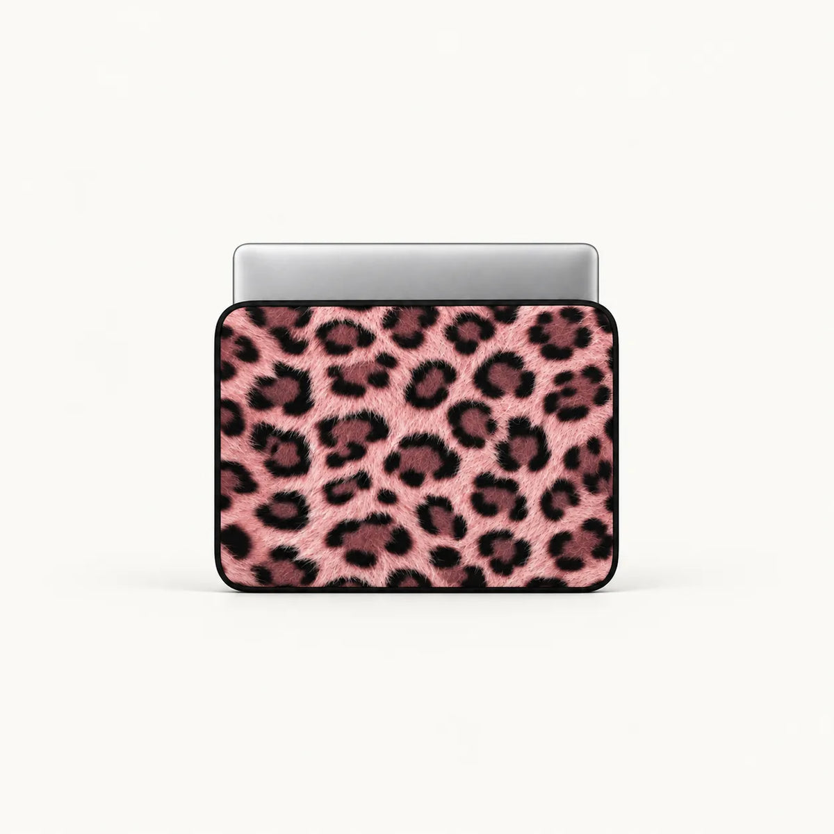 A laptop sleeve featuring a pink and black leopard print pattern, shown with a silver laptop inside on a clean white background.