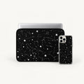 A black laptop sleeve and matching smartphone case with a white starry constellation pattern, shown on a clean white background.