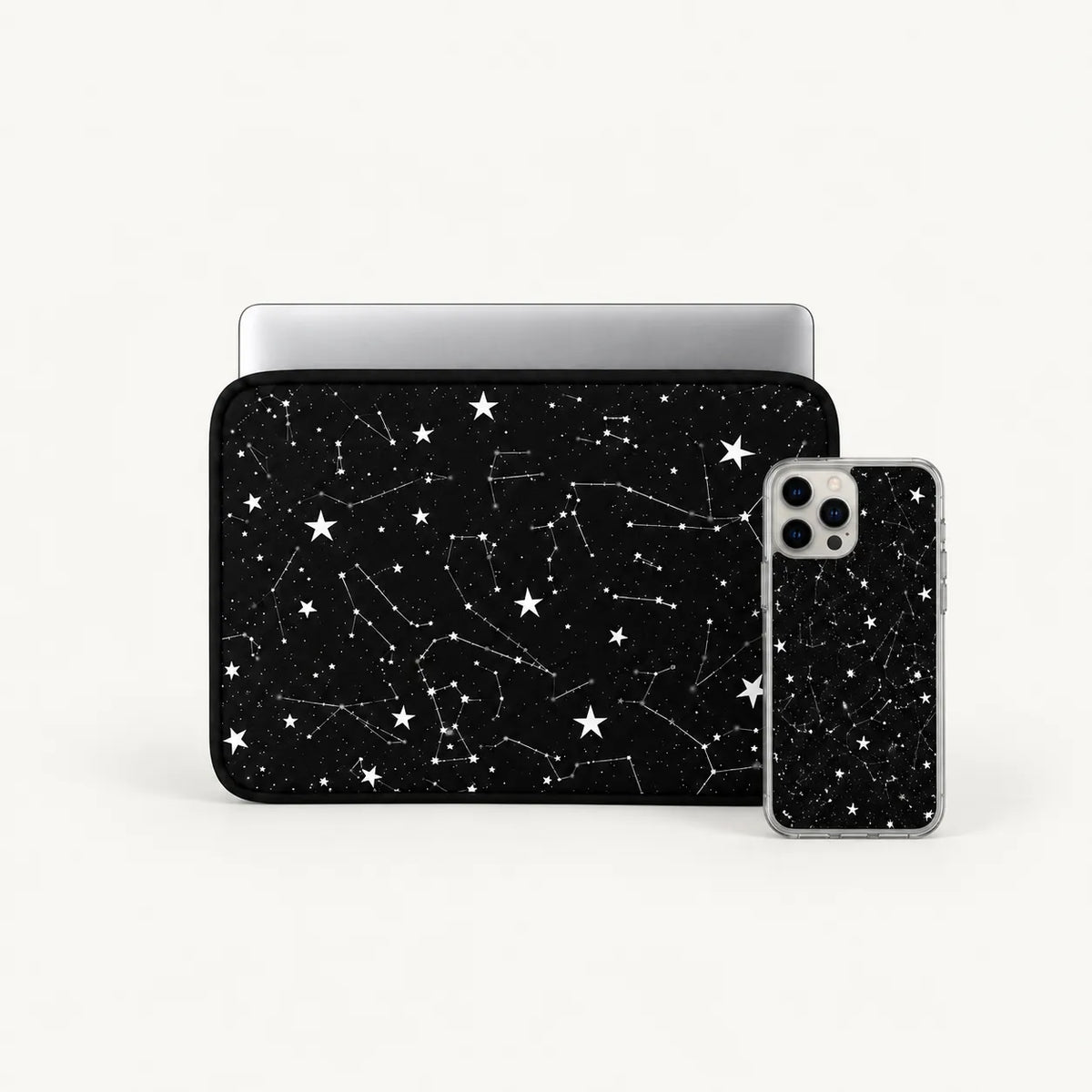 A black laptop sleeve and matching smartphone case with a white starry constellation pattern, shown on a clean white background.