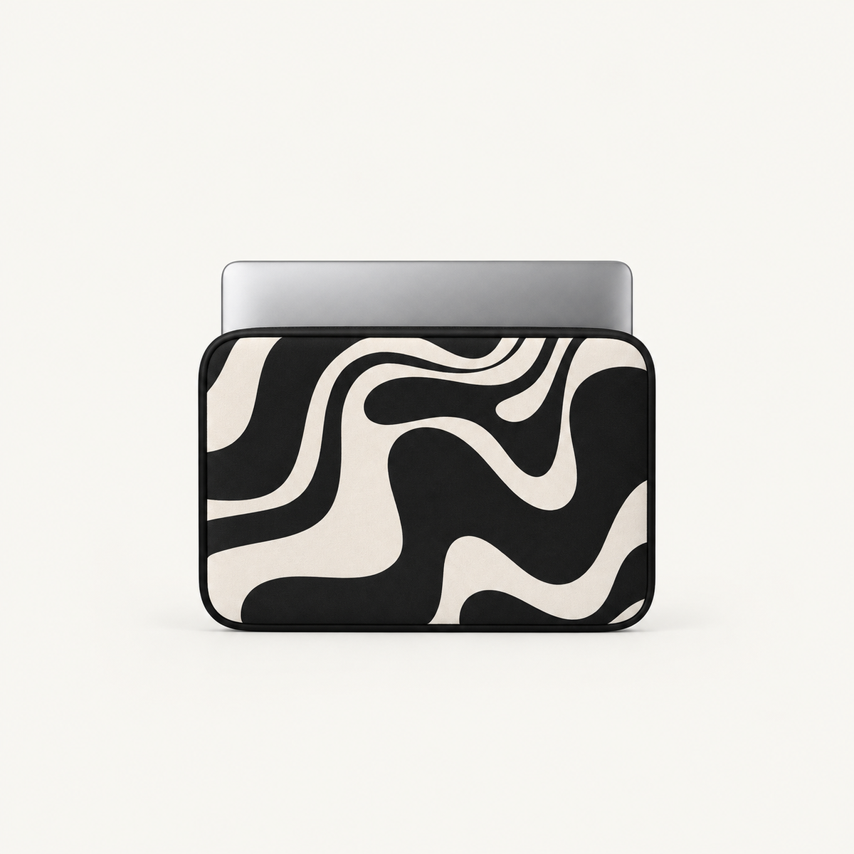 A laptop sleeve with a bold black and cream wavy abstract pattern, shown with a silver laptop partially inserted, on a clean off-white background.