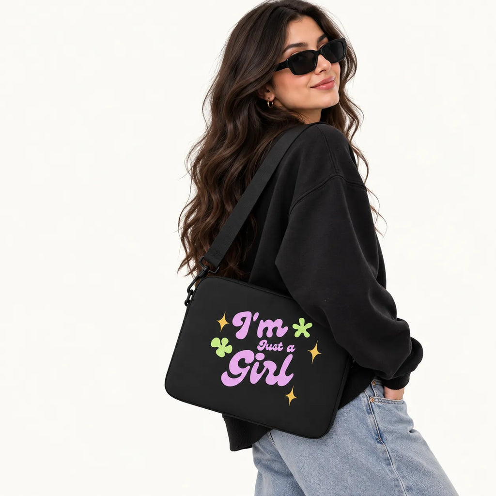 Groovy typography reading I'm Just a Girl in pink with yellow sparkles and green flowers on a black padded laptop sleeve by SLEEVER