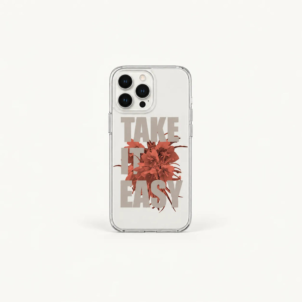 A clear phone case featuring a graphic design with the words 'TAKE IT EASY' in a muted taupe font and a central rust-red abstract floral burst, shown on a light gray background.
