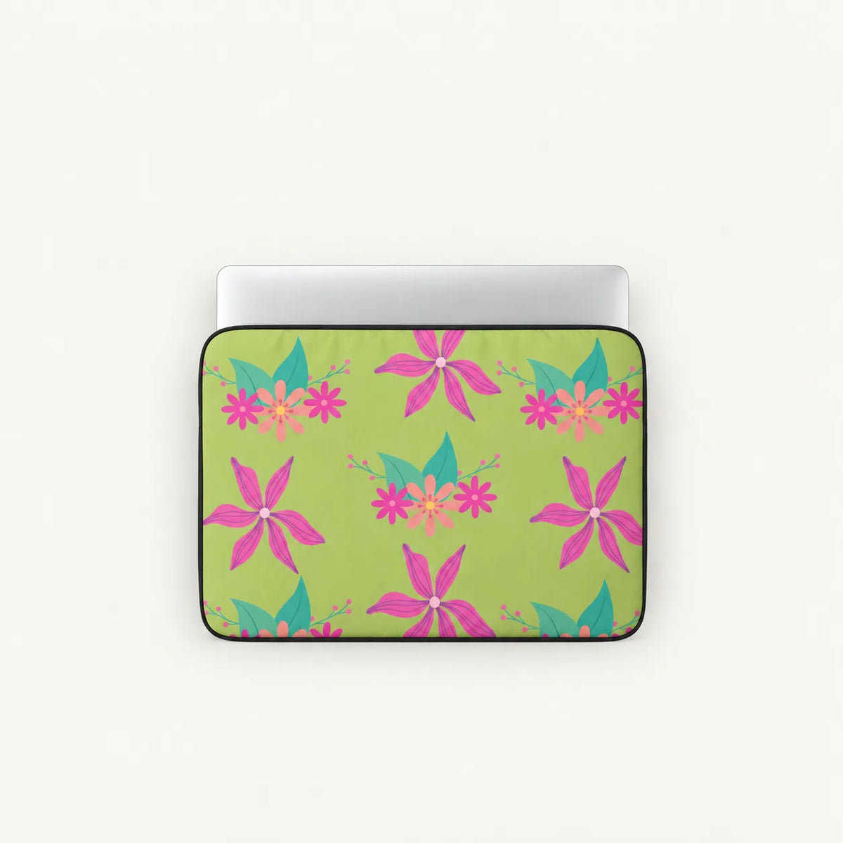 A laptop sleeve featuring a vibrant tropical floral pattern on a light green background, shown with a silver laptop inside. The pattern includes pink hibiscus-like flowers with teal and orange accents.